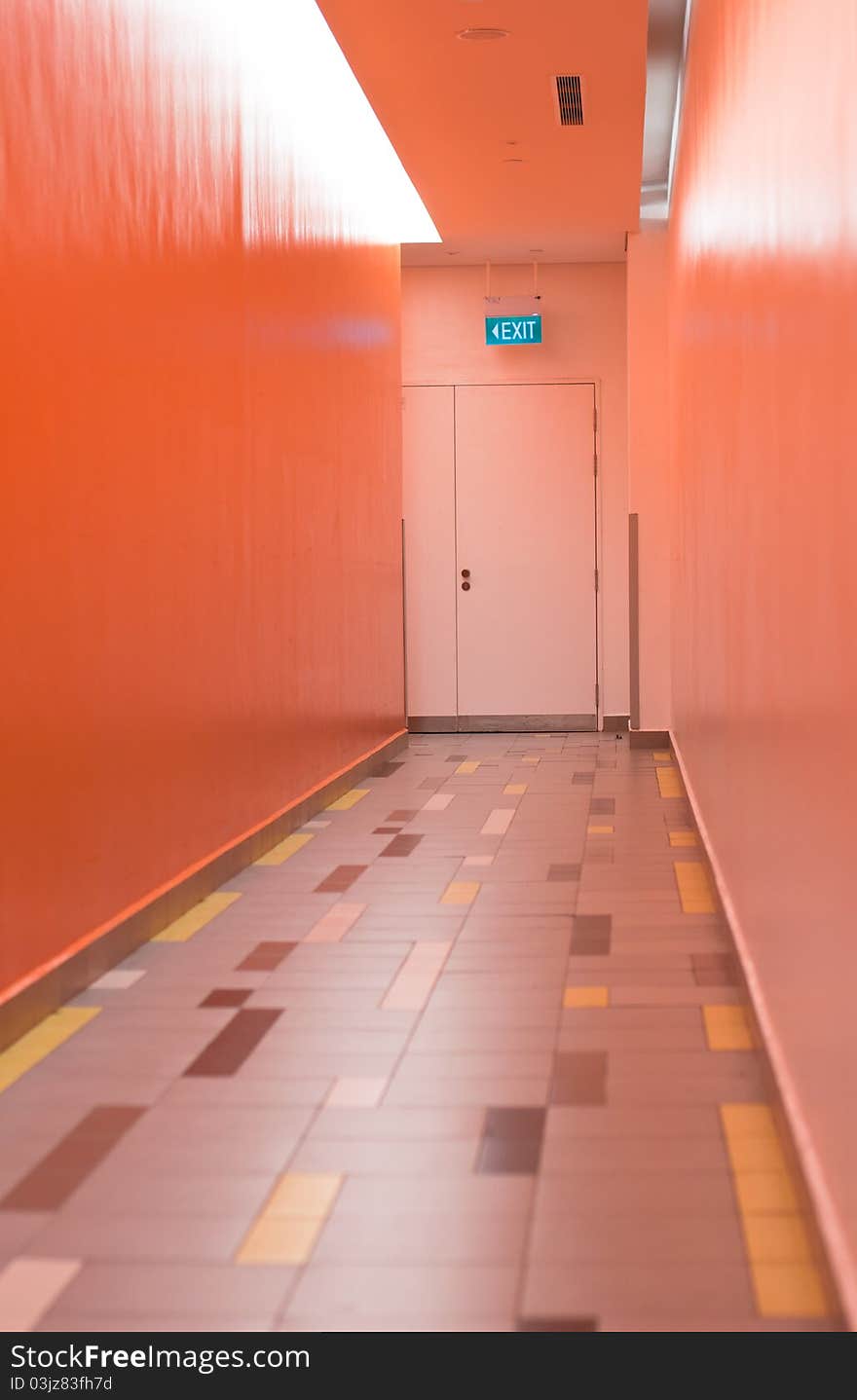 An exit sign on a narrow corridor