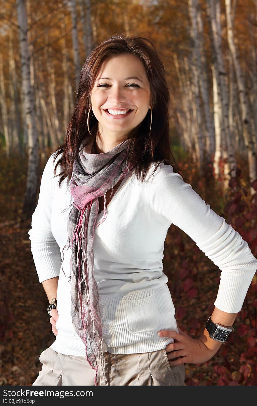 Young attractive smiling girl in autumn park