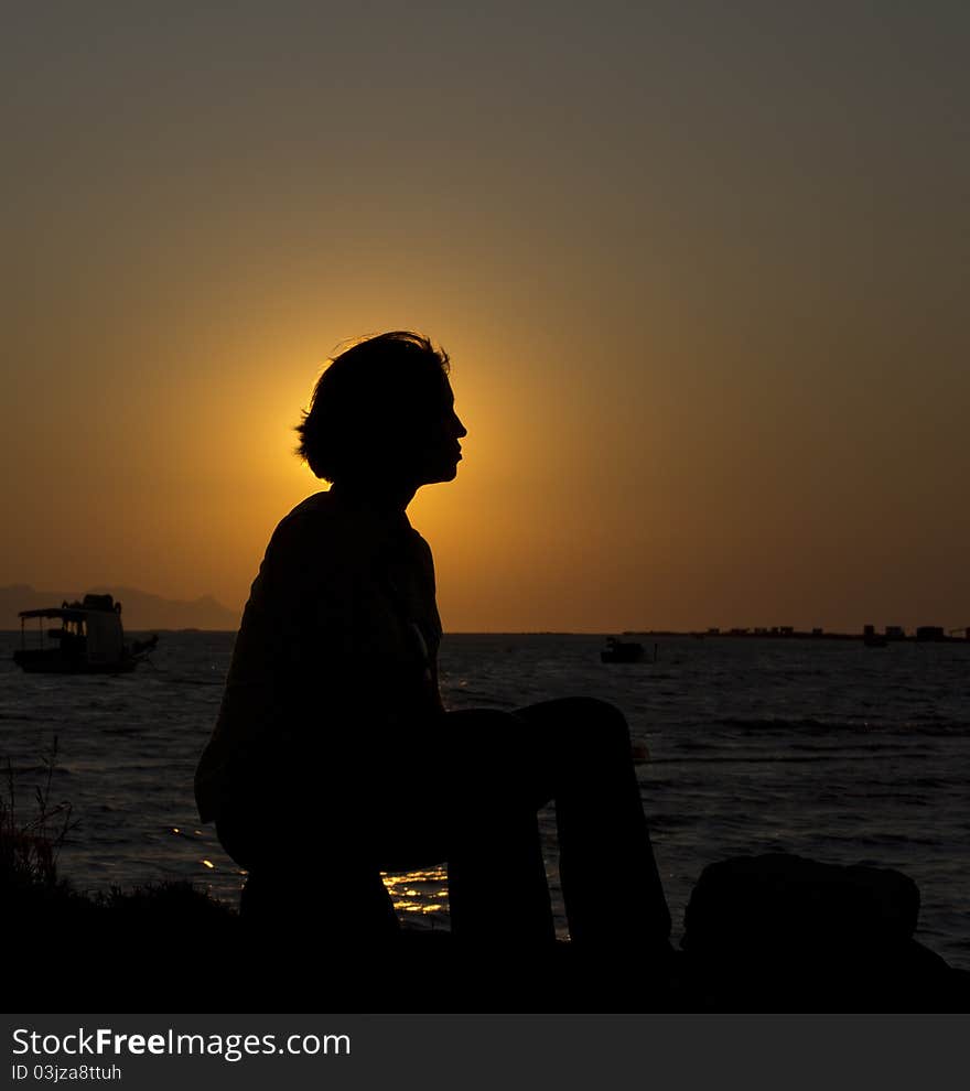 Silhouette of a young woman by the sea. Silhouette of a young woman by the sea