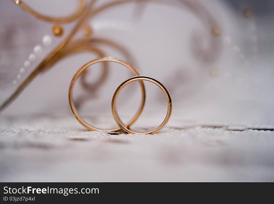 Wedding rings against a glass removed close up