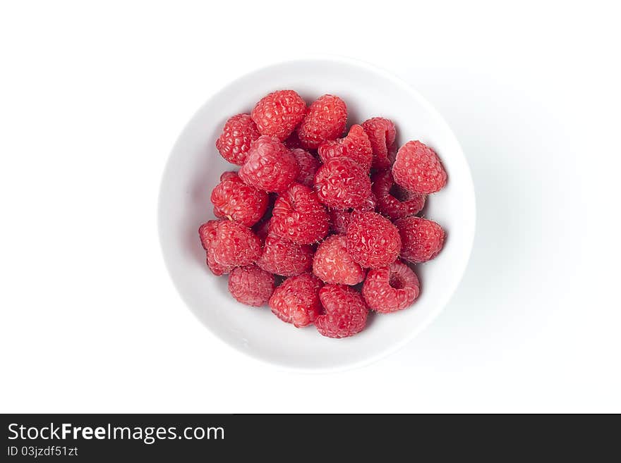 Fresh red raspberries against a white background