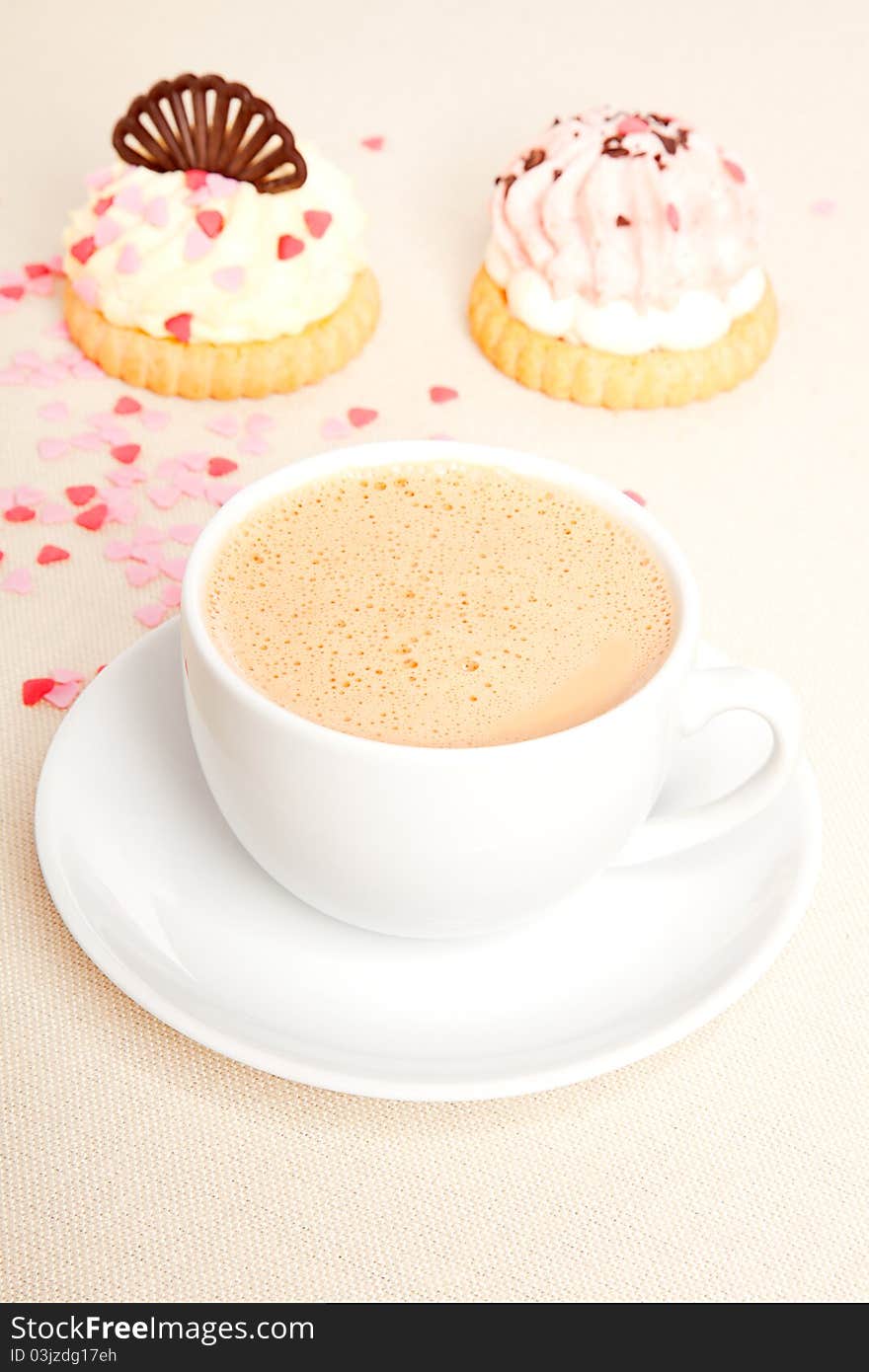 Cup coffee with cake on tablecloth