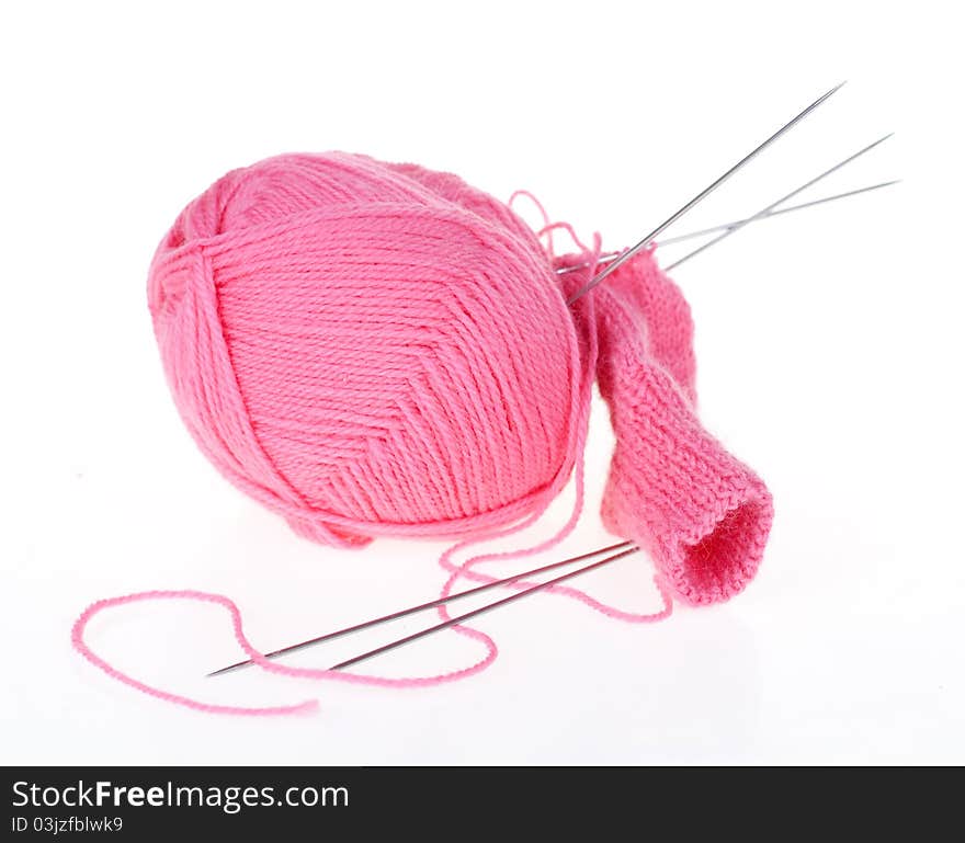 Ball of pink thread and knitting spokes. Ball of pink thread and knitting spokes
