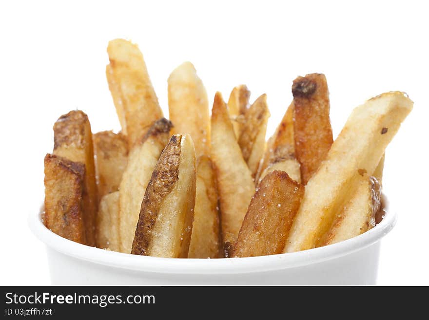 A group of hot french fries against a white background