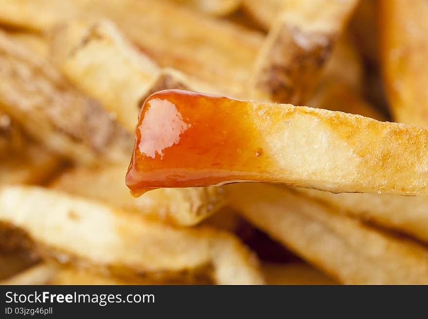 A group of hot french fries against a white background