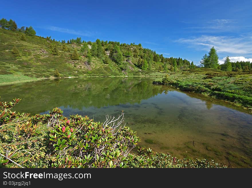 A small mountain lake at 2200 meters on the sea-level near Piz-Tri Peak, Brixia province, Lombardy region, Italy