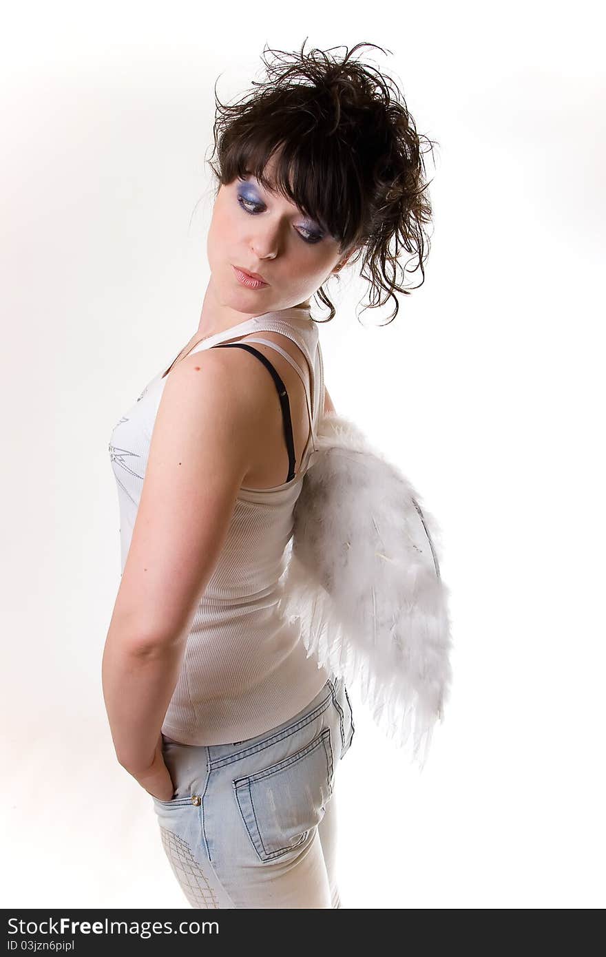 Young girls on white background looks astonishingly on her angel wings. Young girls on white background looks astonishingly on her angel wings