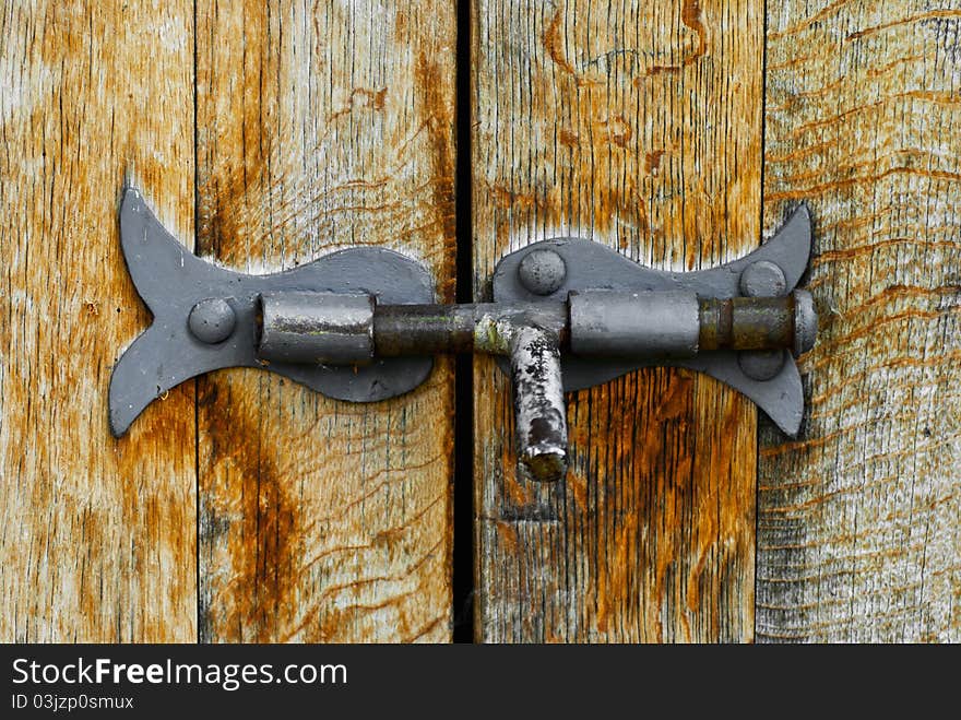 Old steel latch on wooden barrel