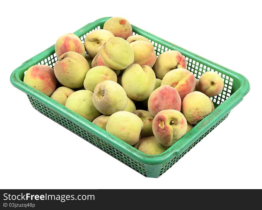 Ripe apricots in plastic basket isolated on white background.