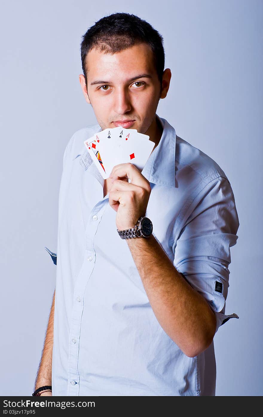 Young man showing a poker hand with four Aces and a King. Young man showing a poker hand with four Aces and a King