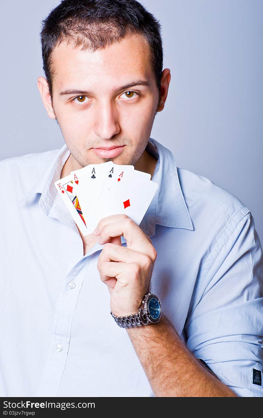 Young man showing a poker hand with four Aces and a King. Young man showing a poker hand with four Aces and a King