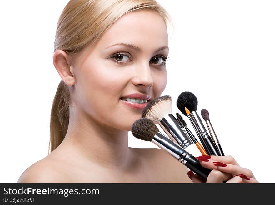 Woman with make up brushes isolated on white