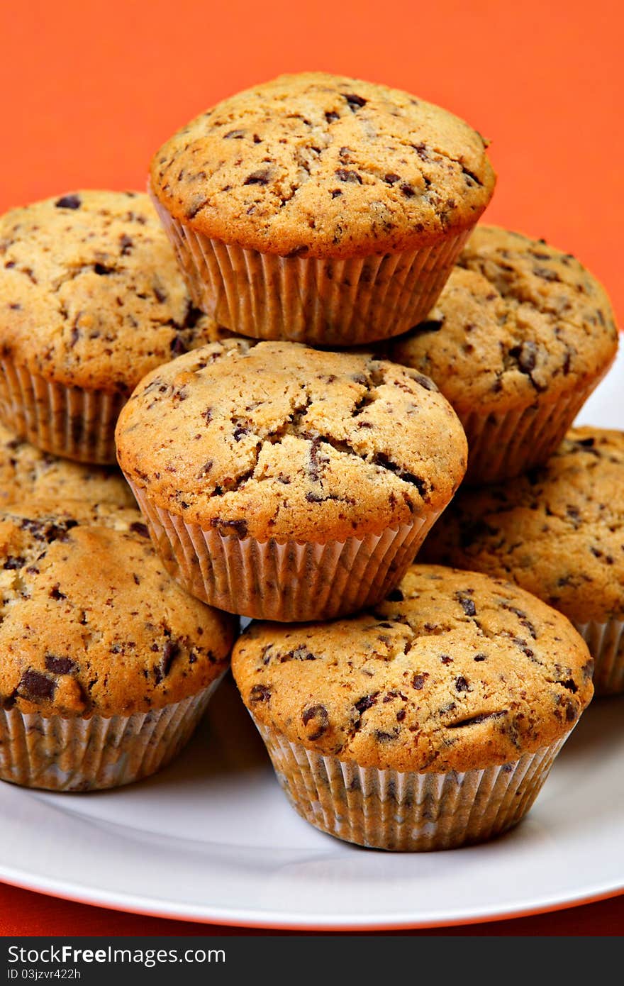 Chocolate chip muffins on white ceramic plate