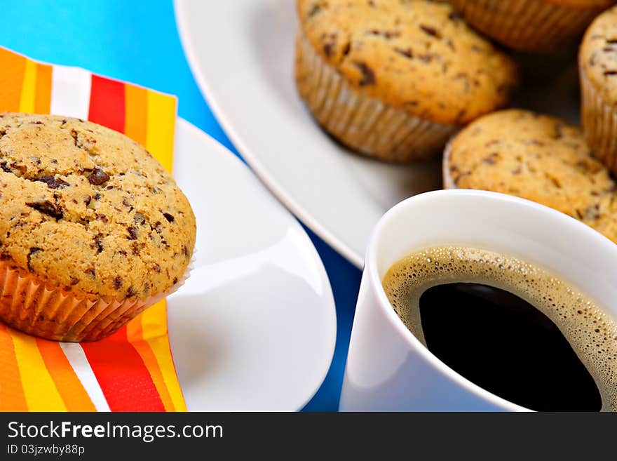 Cup of fresh coffee with chocolate chip muffins. Cup of fresh coffee with chocolate chip muffins