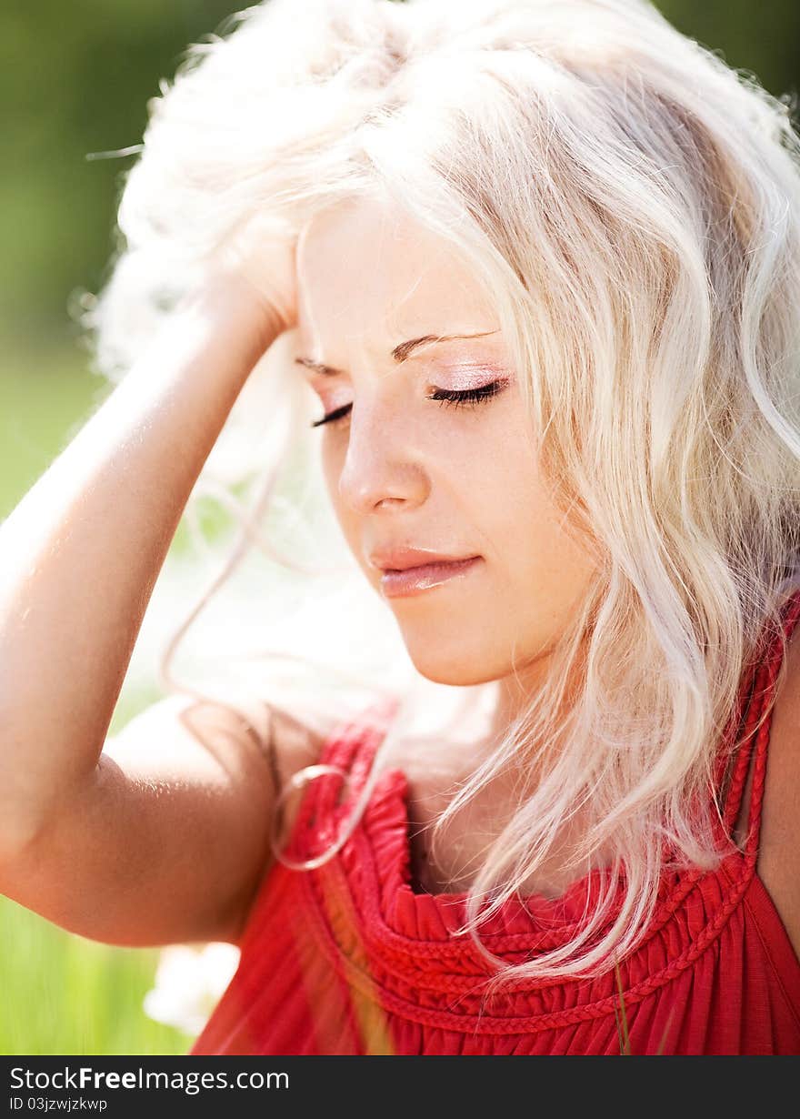 Beautiful sad  woman  on the  meadow on a warm summer day. Beautiful sad  woman  on the  meadow on a warm summer day