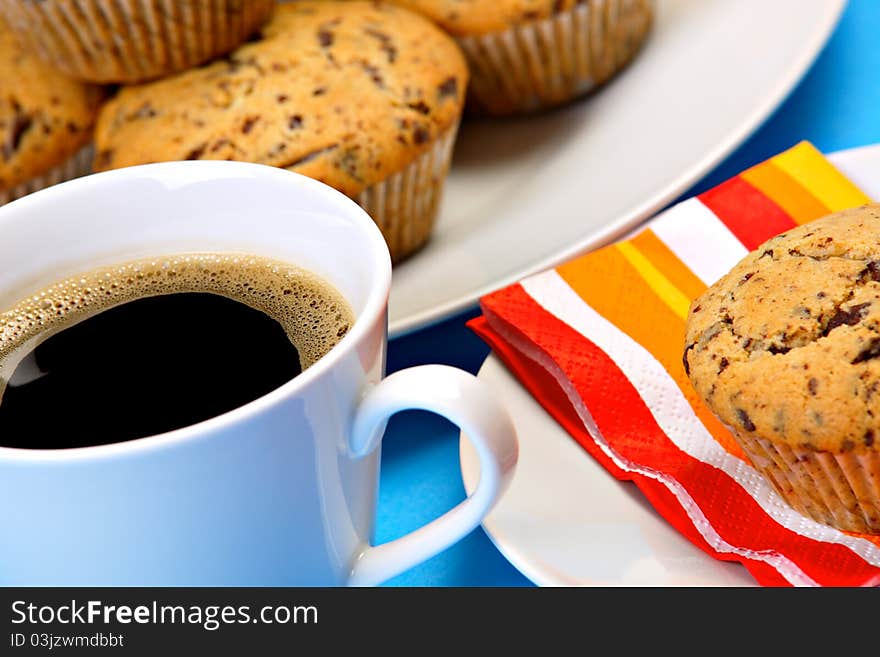 Cup of fresh coffee with chocolate chip muffins. Cup of fresh coffee with chocolate chip muffins