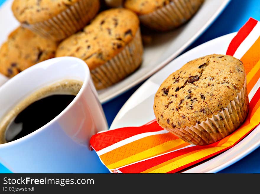 Cup of fresh coffee with chocolate chip muffins. Cup of fresh coffee with chocolate chip muffins