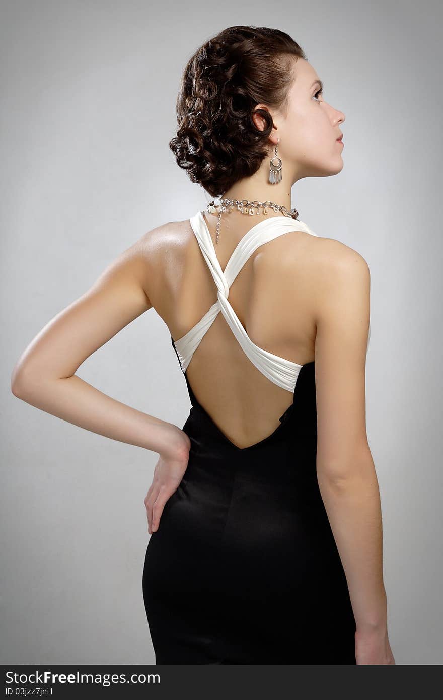 In dress with naked back decollete and bijouterie beads. In dress with naked back decollete and bijouterie beads