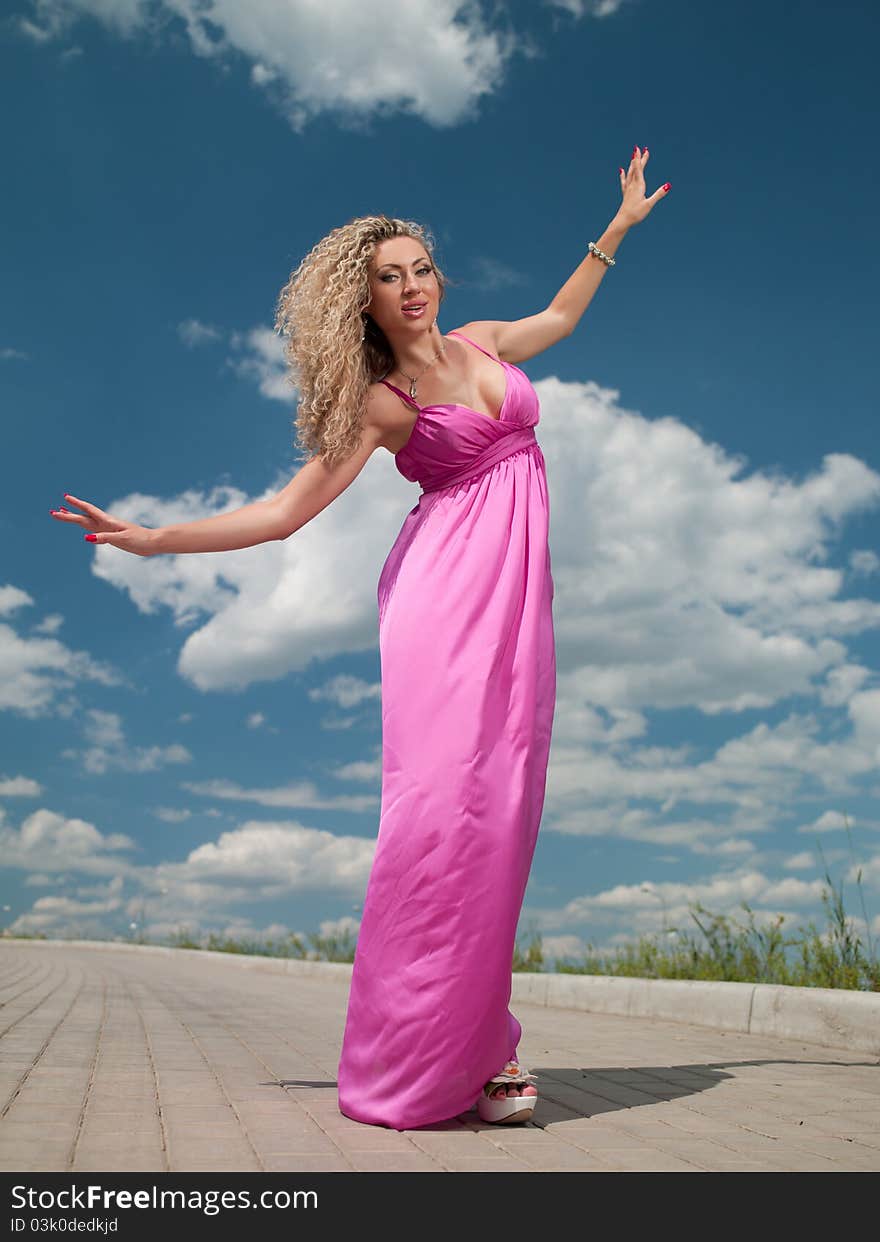 Attractive woman in a pink dress