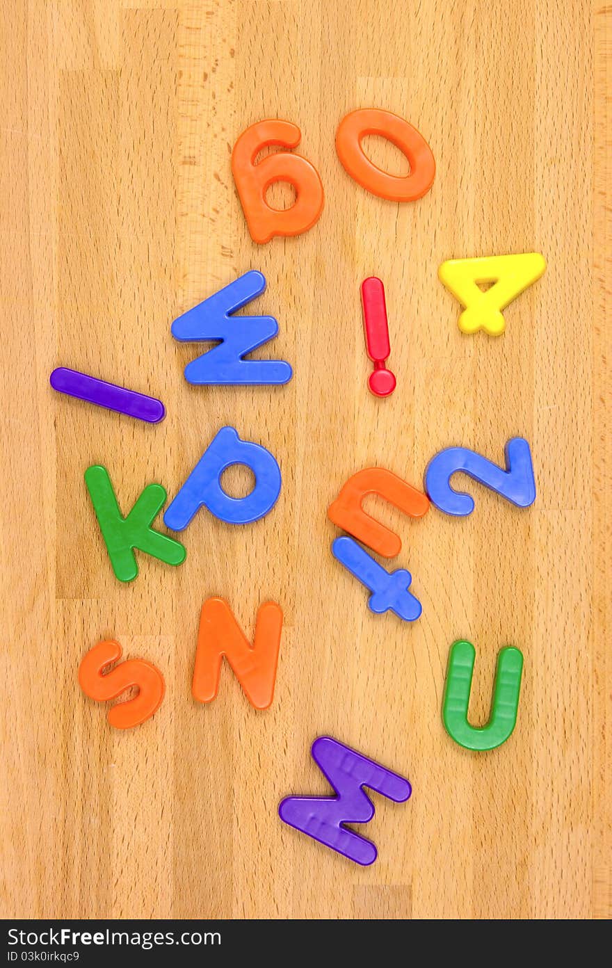 Play letters scattered over a wooden floor