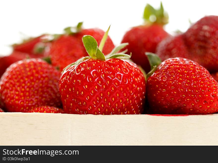 Closeup of fresh ripe strawberries in a wooden box. Closeup of fresh ripe strawberries in a wooden box