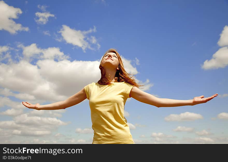 Girl at blue sky background. Outdoor photo.