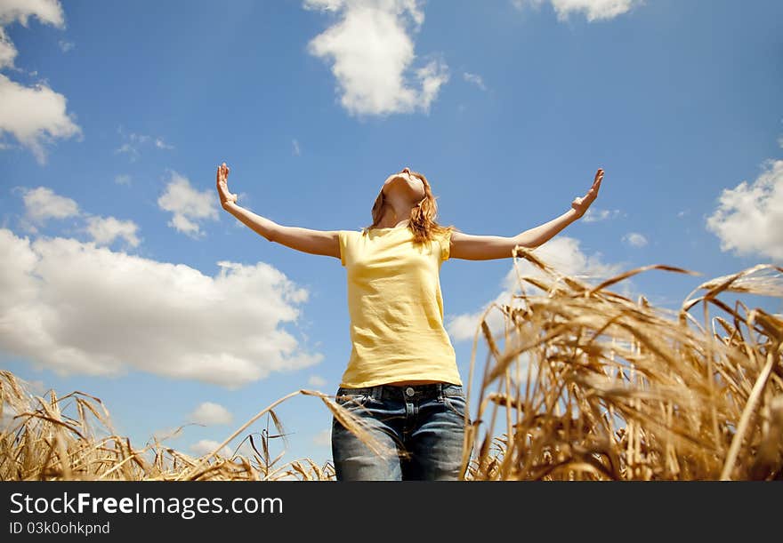 Girl at wheat field at summertime.