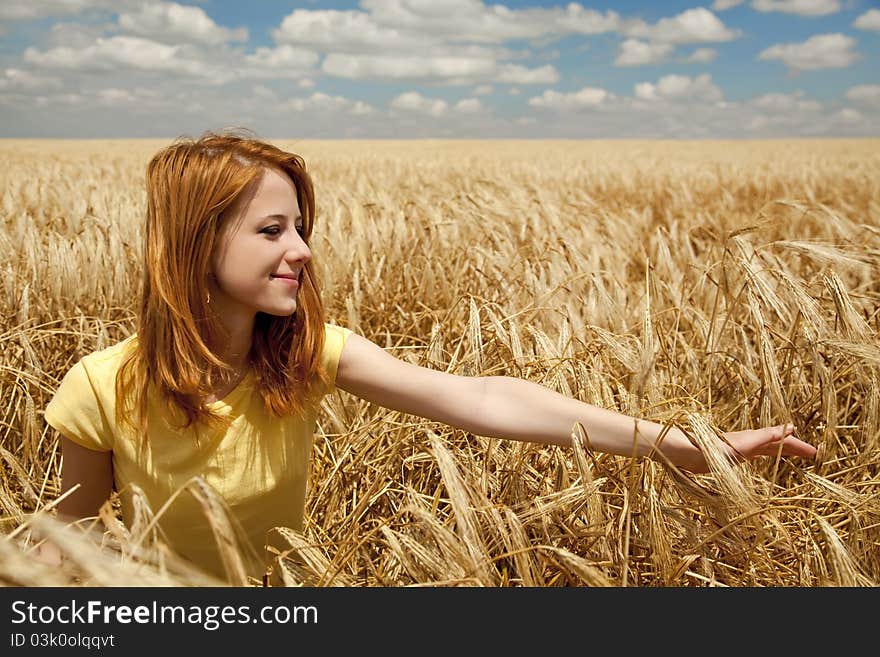 Girl at wheat field at summertime.