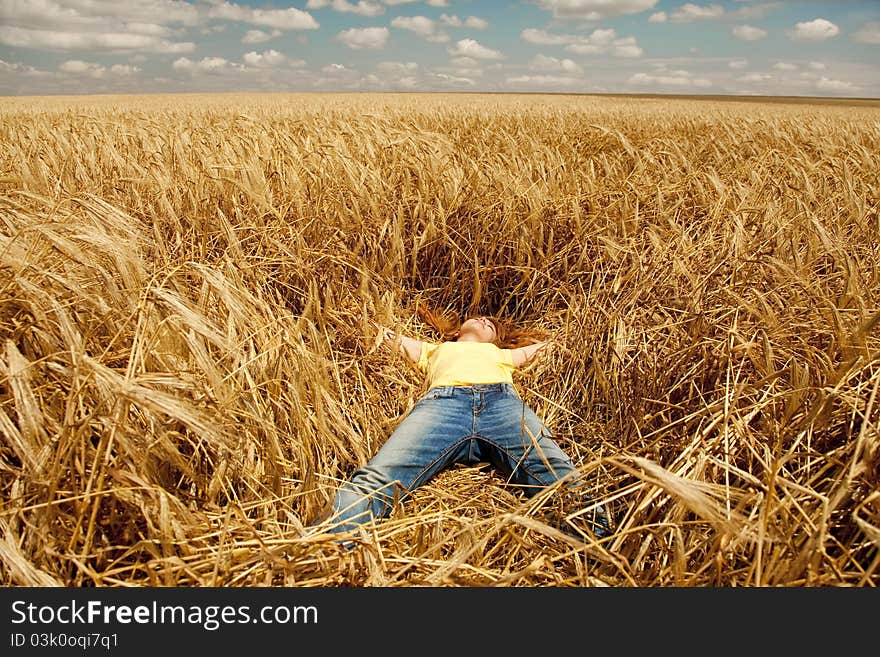 Girl Sleeping At Wheat Field At Summertime.