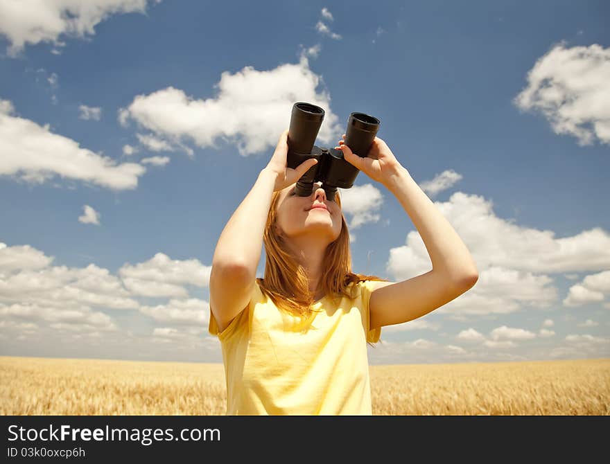 Girl with binocular watching in sky.