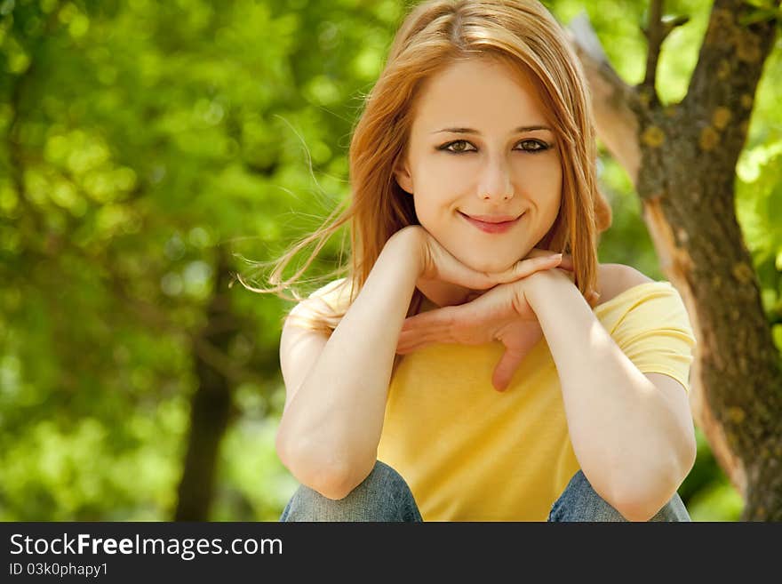 Redhead girl at summer park.