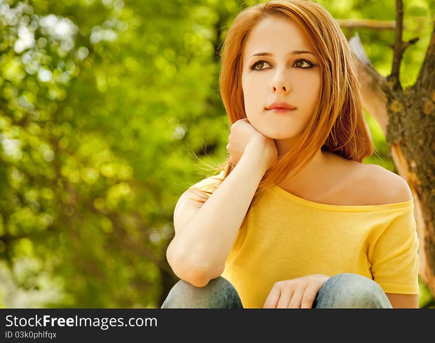 Redhead girl at summer park.