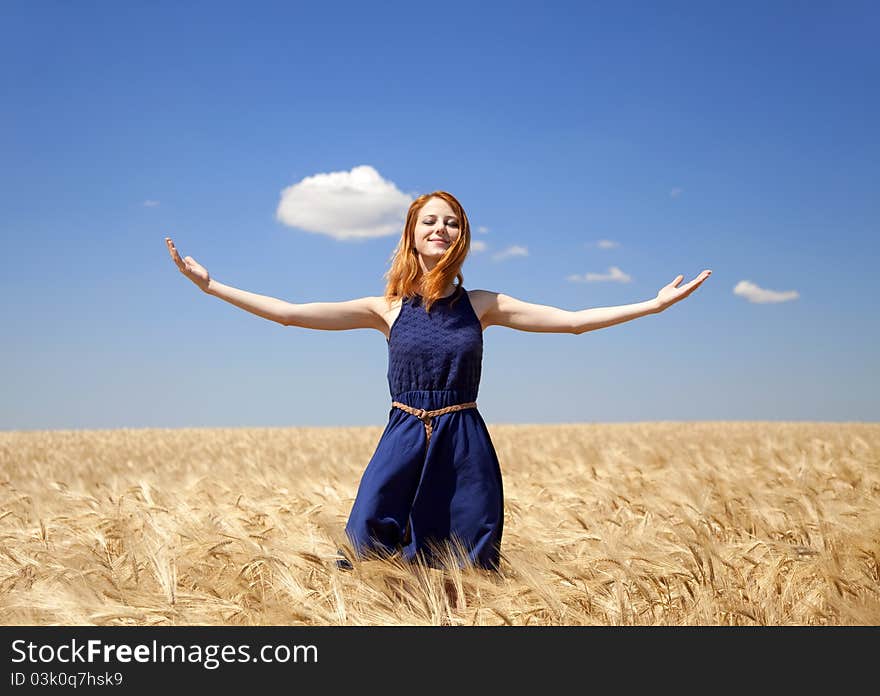 Girl at wheat field in summer day.