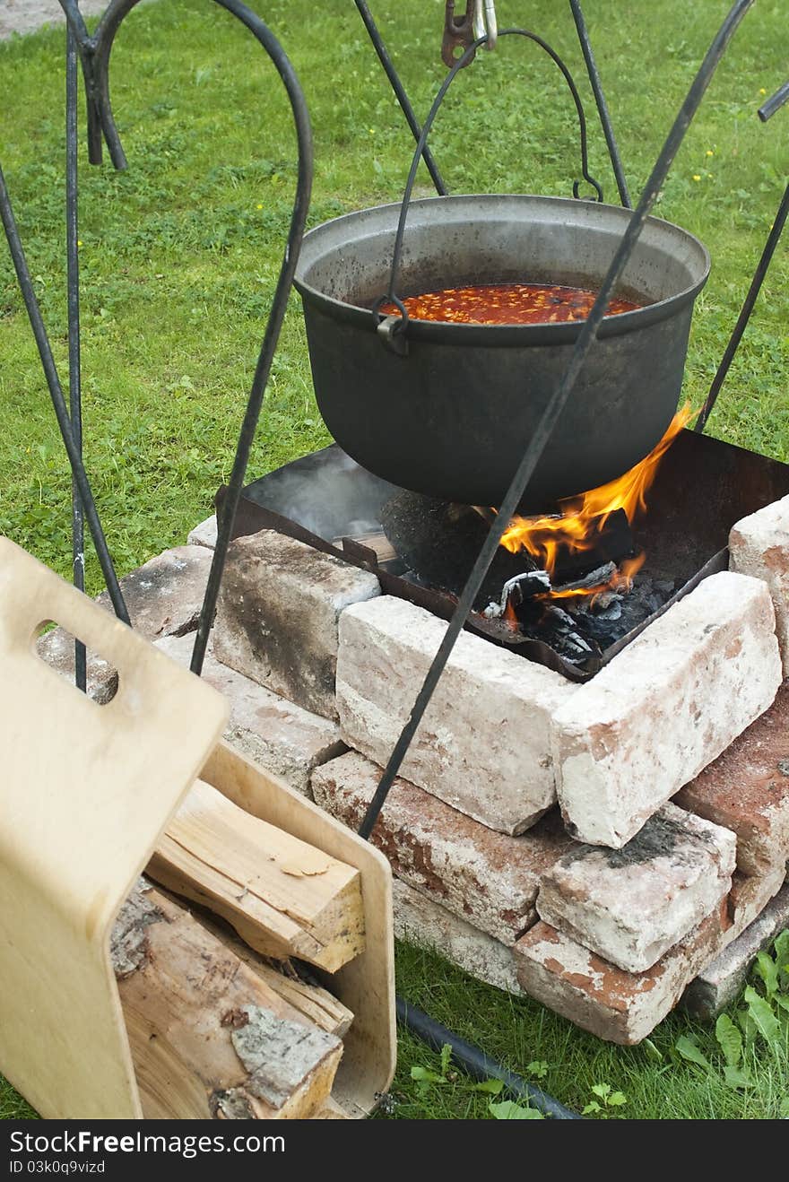 Cooking of soup in the pot on fire. Cooking of soup in the pot on fire