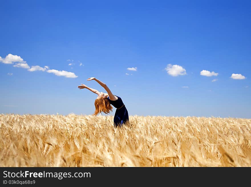 Girl at wheat field in summer day.