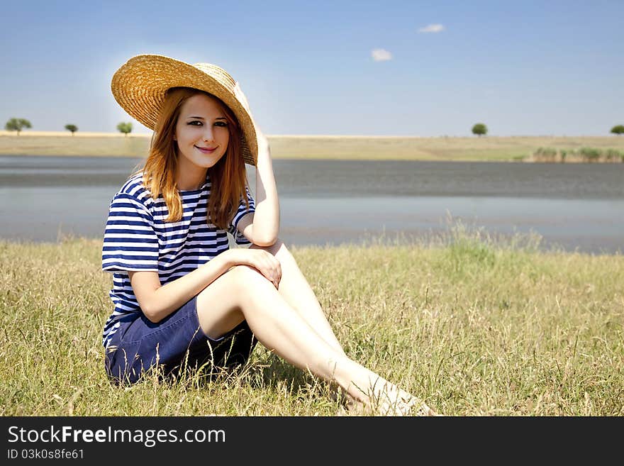 Redhead girl at countryside nead lake.