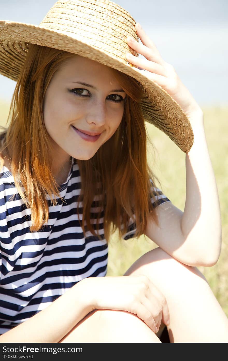 Redhead girl at countryside nead lake.