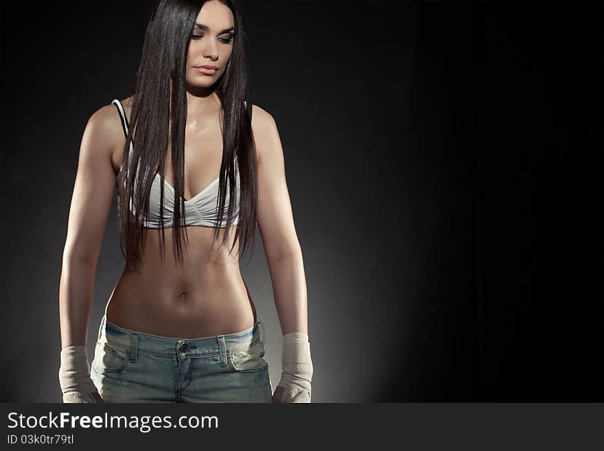 Beautiful woman boxer portrait wearing bandage on hands