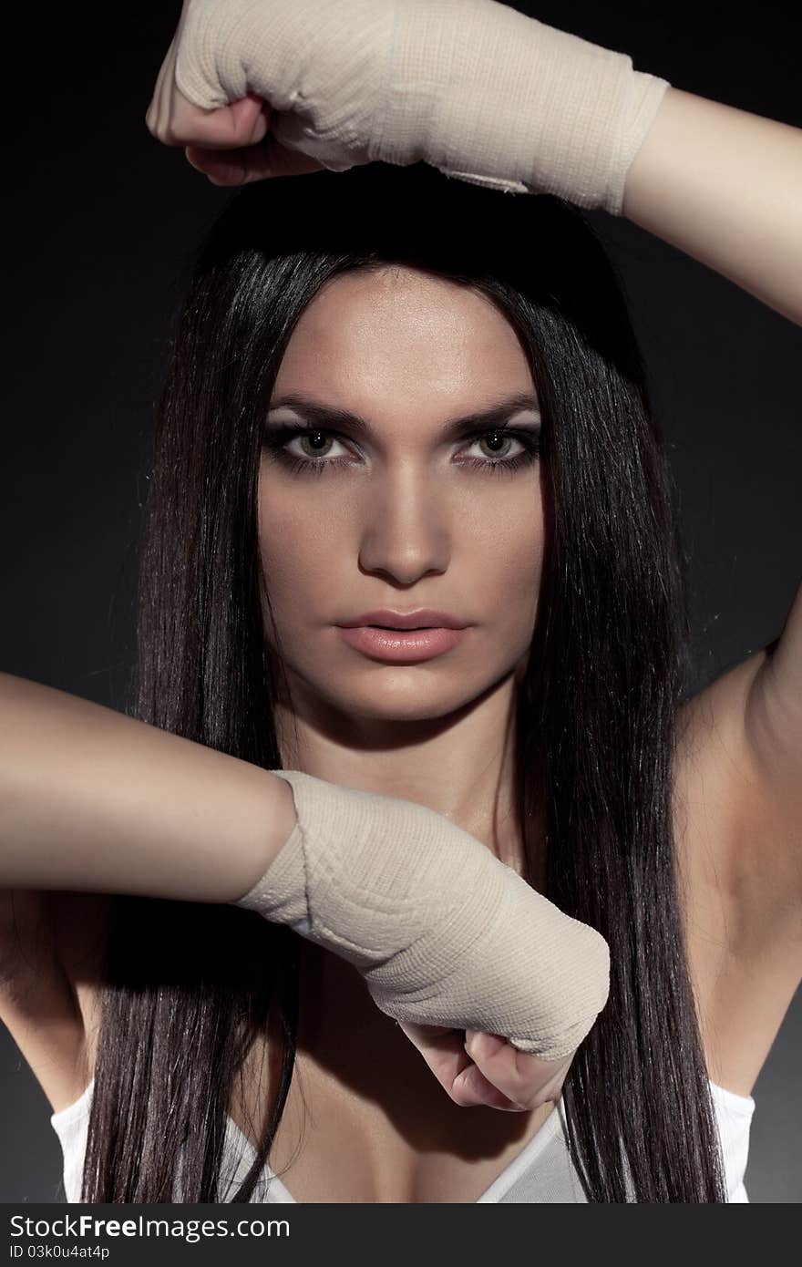 Beautiful woman boxer portrait wearing bandage on hands