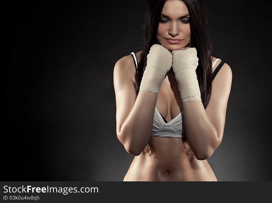 Beautiful woman boxer portrait wearing bandage on hands