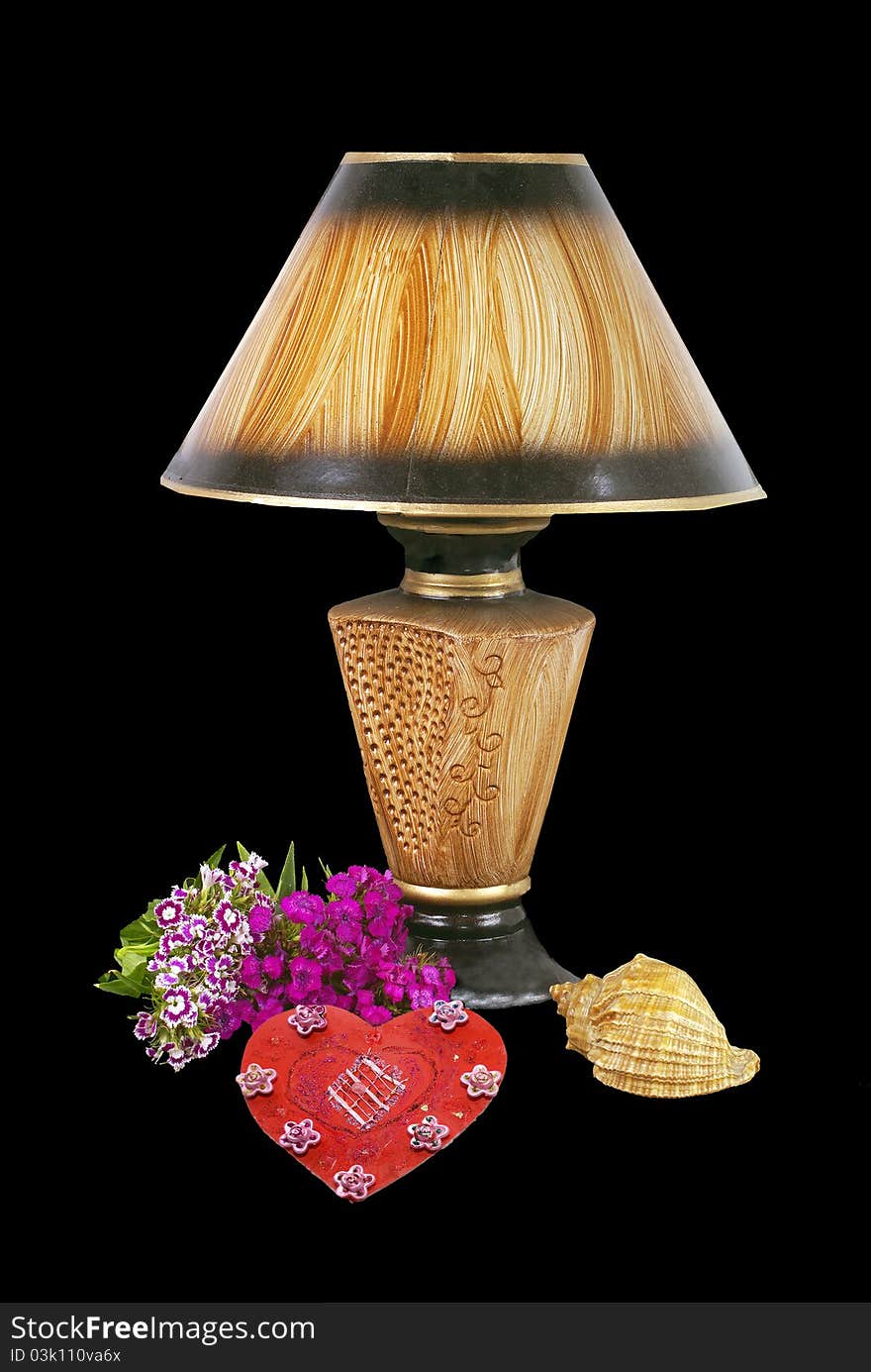 Composition on a desk lamp,flowers,red heart and a sea bowi. Composition on a desk lamp,flowers,red heart and a sea bowi.