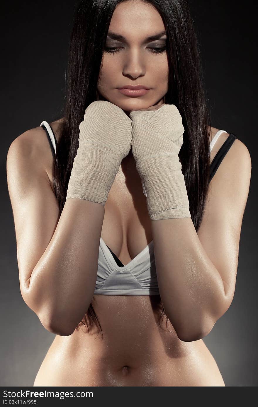 Beautiful woman boxer portrait wearing bandage on hands