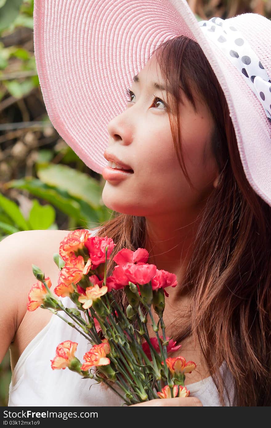 Girl holding flowers looking up. Girl holding flowers looking up