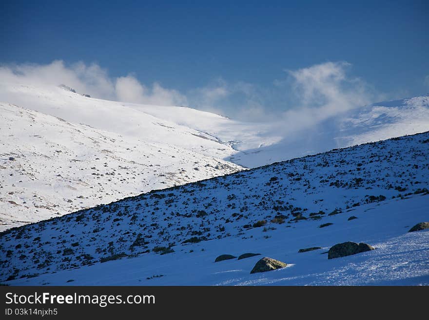 Clouds over snow mountains