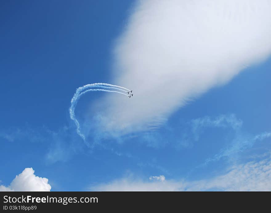 Fly aircraft on a flight show a winding, beautiful blue sky. Fly aircraft on a flight show a winding, beautiful blue sky