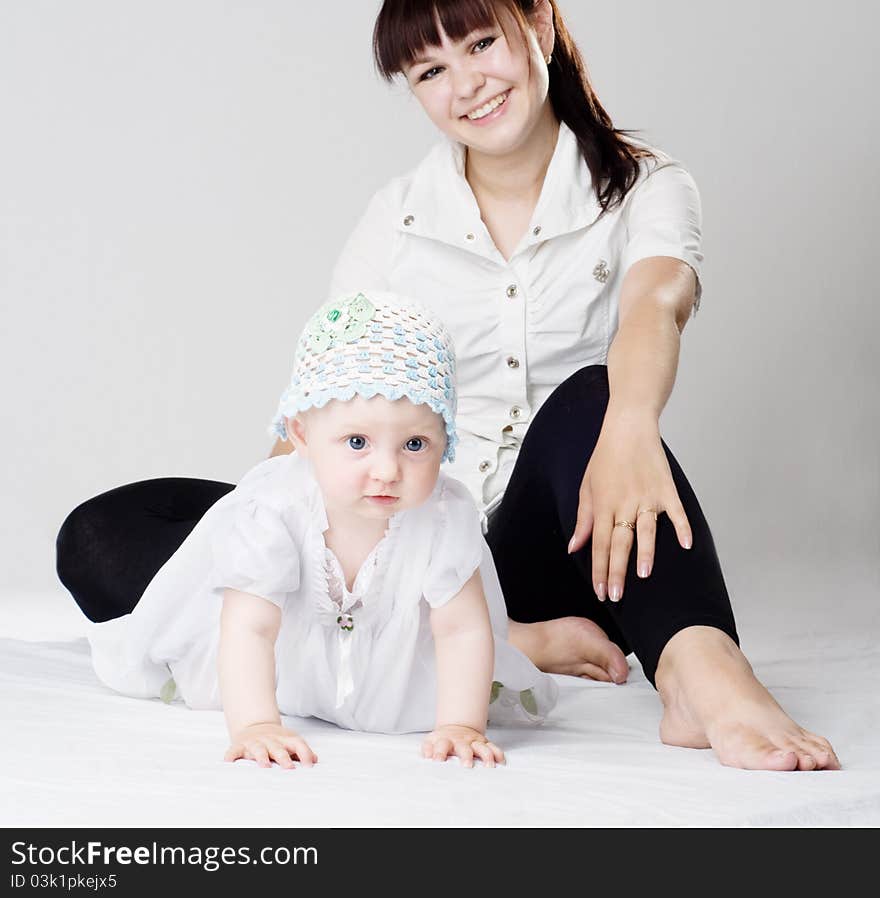 Mother And Daughter Sits On The Floor