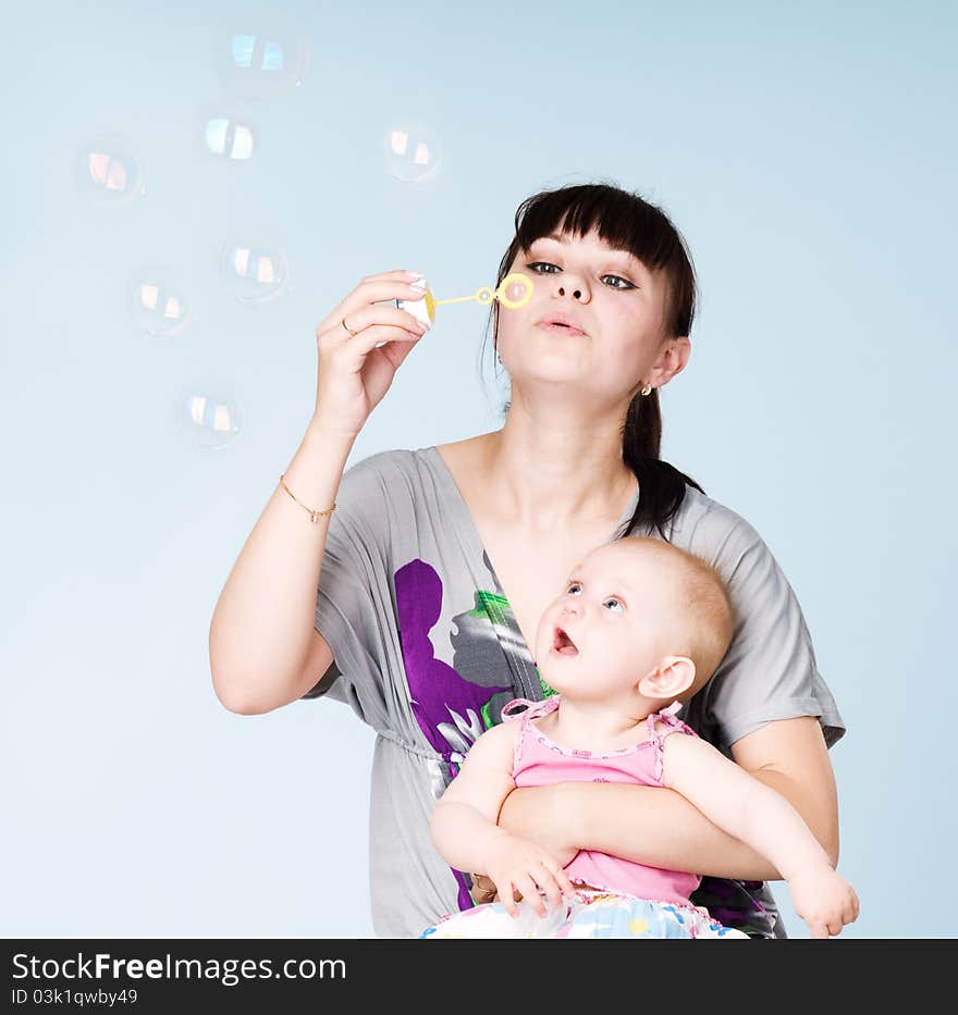 Mother And Daughter Blowing Bubbles