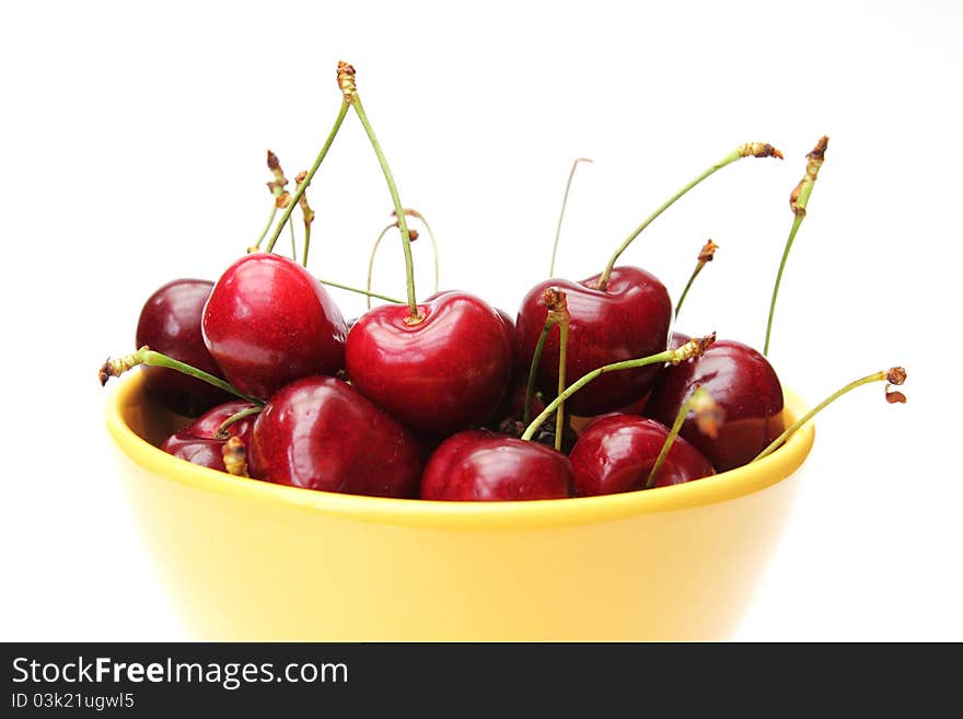 Dish of cherries isolated on white background