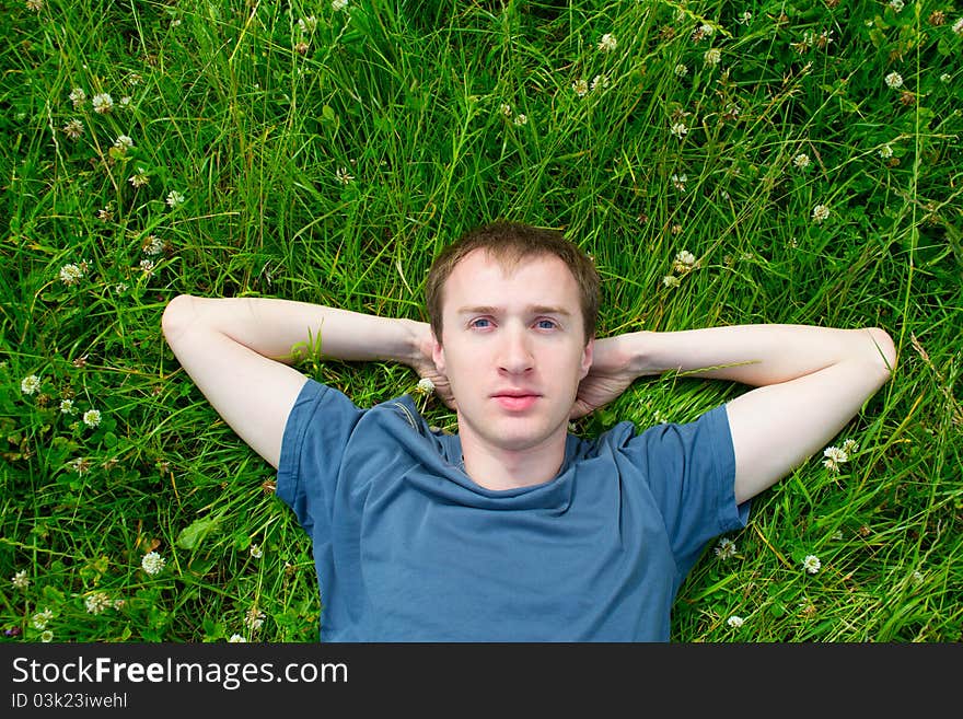 The Young Man Lies On A Green Meadow