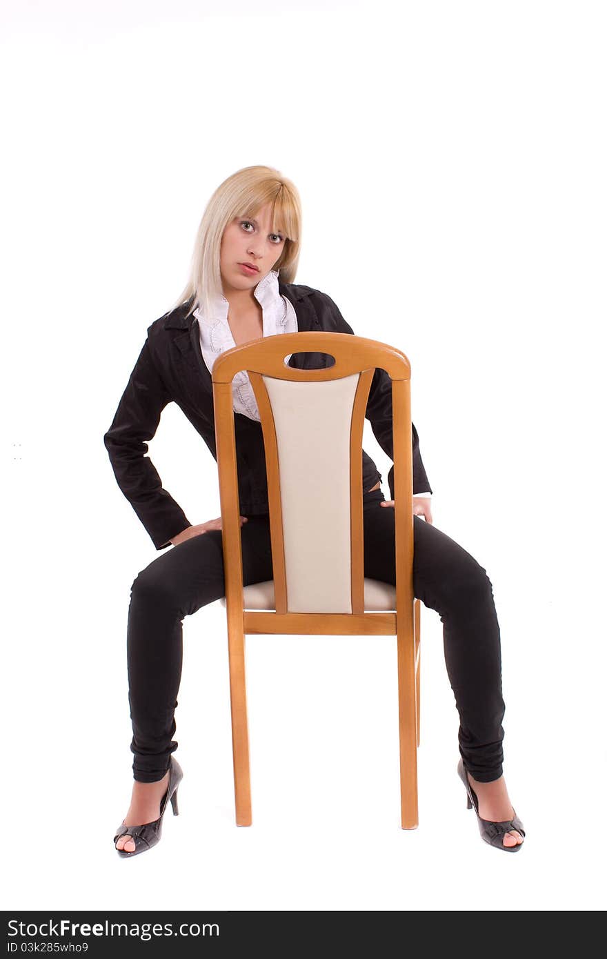 Girl sitting on wooden chair isolated over white